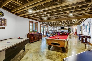 Full Game Room in the Lower Level with: Pool Table, Air Hockey, Ping Pong, Foosball, Poker Table, and Living Space for Movie Night