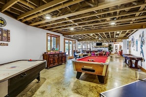 Full Game Room in the Lower Level with: Pool Table, Air Hockey, Ping Pong, Foosball, Poker Table, and Living Space for Movie Night