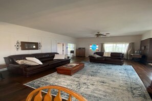 Living room with couch/love seat and 55 inch TV.