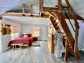 Queen bed and the stairs to the loft