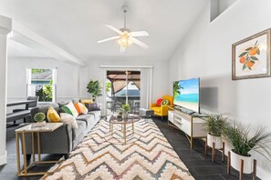 Bright and inviting, this vibrant living room features a Smart TV and comfortable seating – perfect for relaxing or entertaining.
