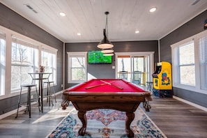 Dive into entertainment in this cabin’s game room, with a pool table and arcade games to enjoy.