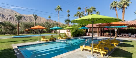 Entertainer's paradise with a pool, pickleball court, bocce ball area, and tons of outdoor lounge space.