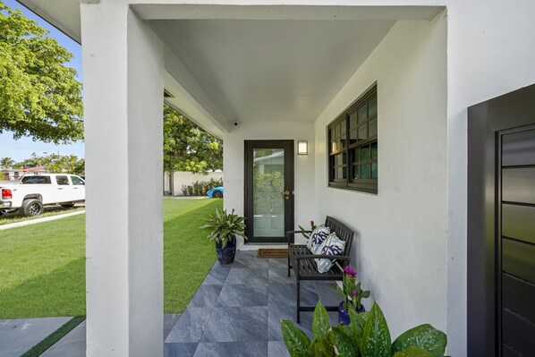 A small chair to relax in front of the front door with the street view. UNIT A