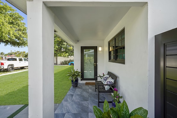 A small chair to relax in front of the front door with the street view. UNIT A