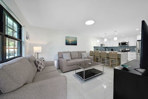 Spacious living room right across the dining area and kitchen.