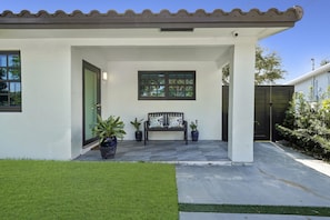 A small chair to relax in front of the front door UNIT A on the right side of duplex