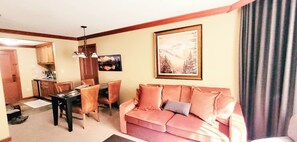 Spacious living area with sofa sleeper and dining table