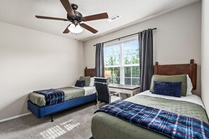 Bedroom 4 with two twin beds and a quiet working space.
