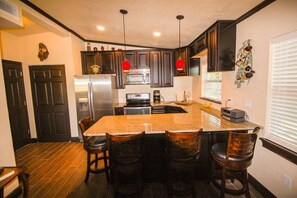 Kitchen with granite peninsula for dining and socializing.  