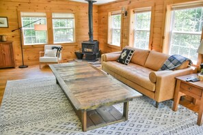 Our great room features a wood burning stove, Poly & Bark sofa, Pendleton blanket, and smart TV.