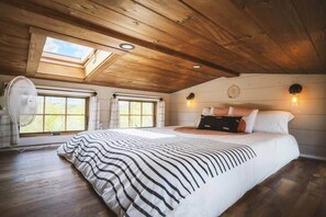 Our bedroom loft with Casper queen mattress, fan, skylight (with shade), and plenty of windows overlooking our five acres of wetlands preserve.