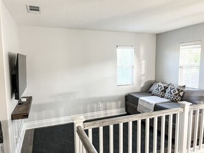 Cozy up in the living room, complete with a large TV for all your favorite shows and movie nights!