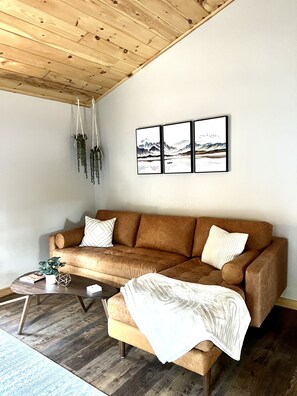 Living room with extra comfortable leather sofa for snuggling on chilly nights.