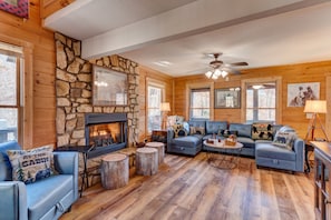 Living Room: Leather sofas, additional "stump" seating, 50" tv, gas fireplace
