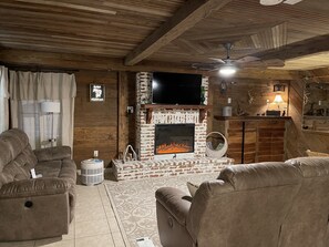 Living room with 2 full sofas with recliners and also a wing back chair