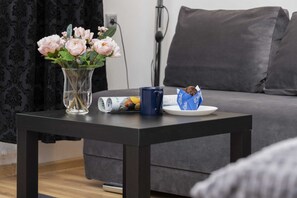 A close-up of the coffee table, elegantly decorated with flowers and tea, creating a cozy and inviting atmosphere.
