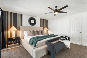 Relaxing Primary Suite with king bed, ceiling fan and hotel quality linens