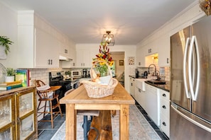 Farmhouse sink, subway tiles, and stainless steel appliances