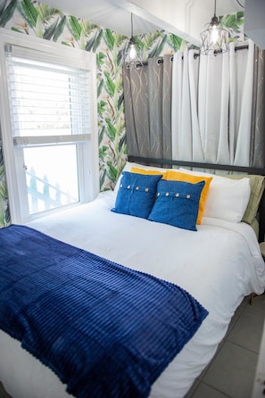 The recently redesigned bedroom boasts the coziest queen size bed and fluffiest comforter!