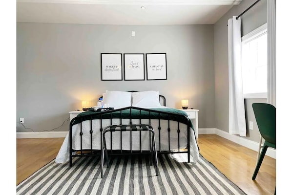 Bedroom with queen sized bed and twin bunk beds