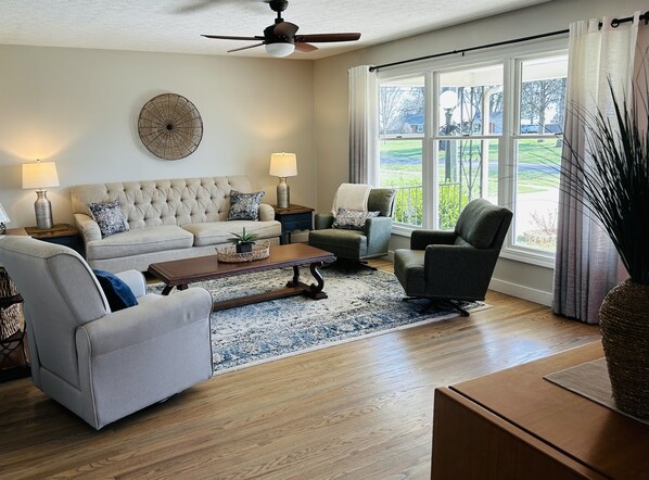 Natural light floods this beautiful LR area with 3 swivel chairs -- perfect for conversation or watching a movie.