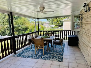 Huge tiled balcony overlooking quiet back yard makes this a great place for reading, board games, meals and more!