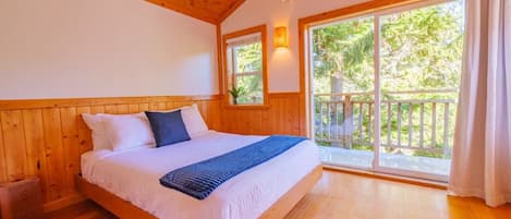 Queen bed with inlet and tree views.