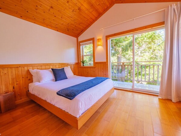 Queen bed with inlet and tree views.