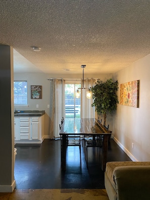 Dining room with sliding glass door out to backyard.