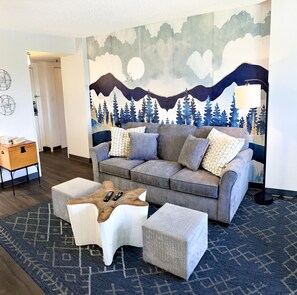 The sofa sleeper in the living room accommodates two people.