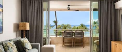 Living room & lanai with panoramic 180° ocean, sunset, West Maui Mountain and Lanai Island views. 75" 4K smart Sony TV. Sonos soundbar. AC throughout. The lanai sliders open up to create indoor outdoor living Hawaii style.