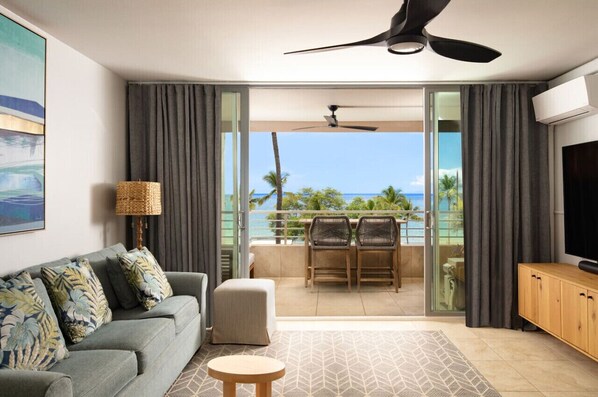 Living room & lanai with panoramic 180° ocean, sunset, West Maui Mountain and Lanai Island views. 75" 4K smart Sony TV. Sonos soundbar. AC throughout. The lanai sliders open up to create indoor outdoor living Hawaii style.