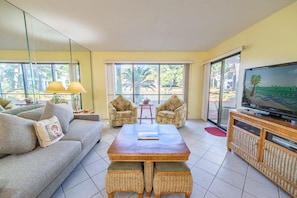 Your open floor plan great room opens onto the main patio and is furnished with a sleeper sofa and two comfy chairs.