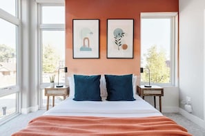 Bedroom 2 with queen bed and floor to ceiling windows