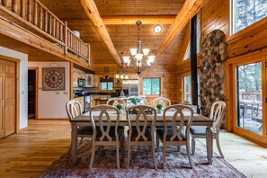 Front view of kitchen and dining room space, kitchen is fully stocked.