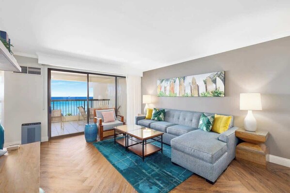 The living room is brightly lit and features a comfortable couch