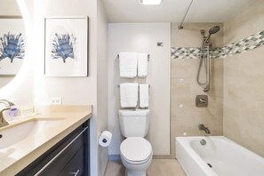 Clean and bright bathroom with shower and tub