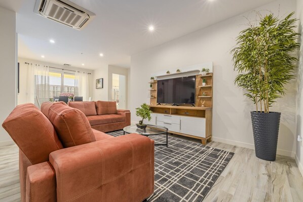 Entertain your friends to this cozy living room with a television, comfortable sofa, and mirrored center table. The sofa can also serve as an additional bed.