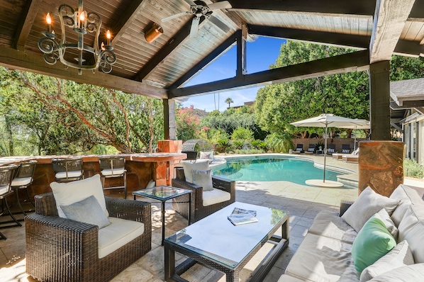 The gazebo and grill area, providing a scenic view overlooking the pool.