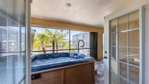 French doors open from master bedroom to lanai and stand-alone hot tub