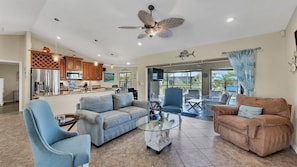 Open living space overlooks the pool and canal beyond