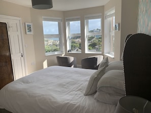 Bedroom with en-suite shower, view to the village sea