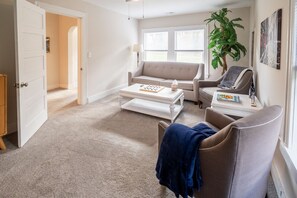 Living room with pull out sofa bed, games and fireplace.