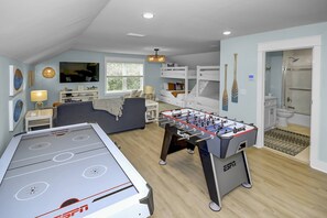 Large loft with game air hockey/ping pong, foosball, full bathroom, sitting area, and 2 sets of built-in full/queen bunks!