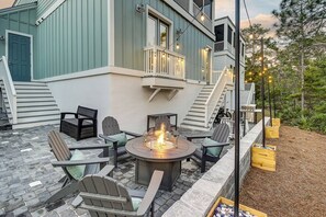 Outdoor entertaining area, complete with a paver patio that backs up to a private wooded area, and a propane grill