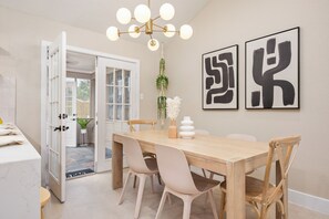 An elegant dining space illuminated by soft lights and artwork