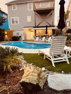 Large pool deck with chaise lounges