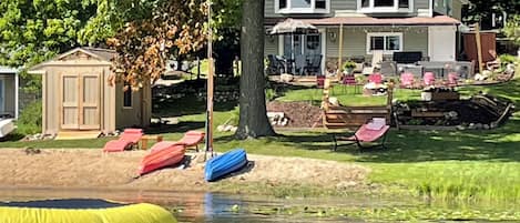 View of house from the lake. In picture is water trampoline & lily pad float.