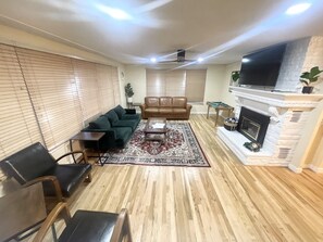 living room with gas fireplace and mini pool table